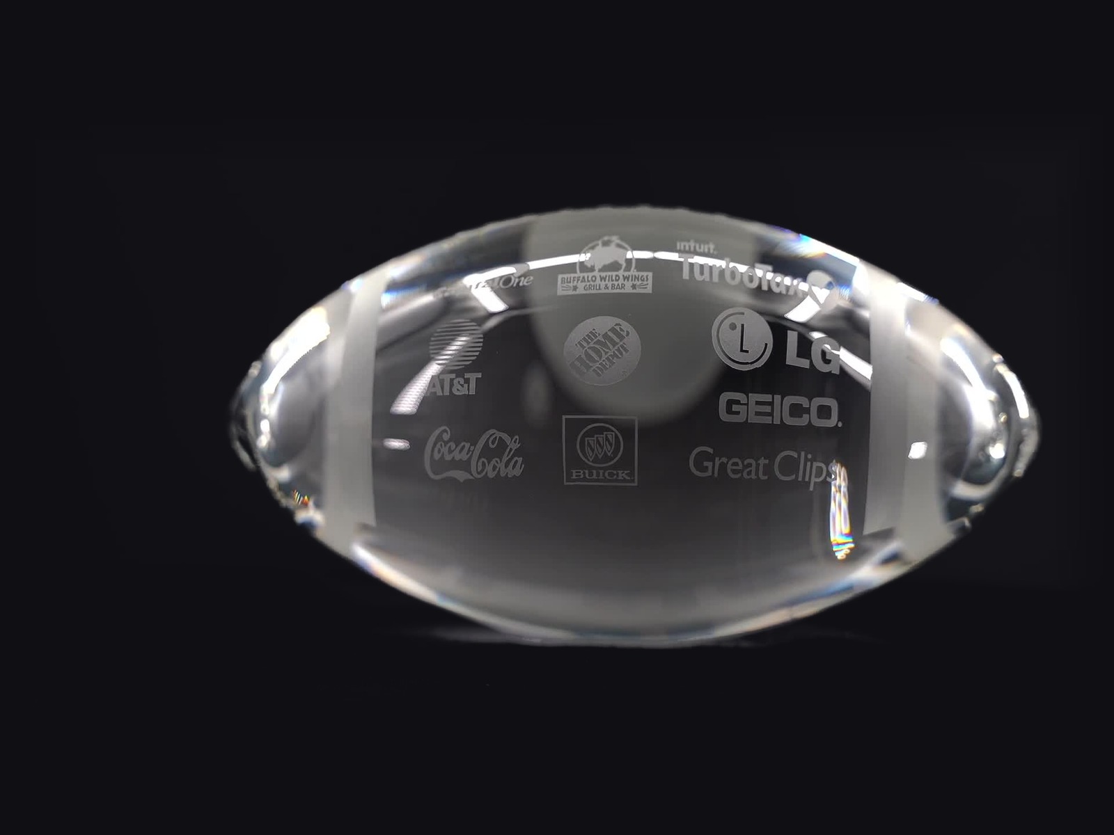 Medium clear crystal football, masterfully etched with sample sponsor logos