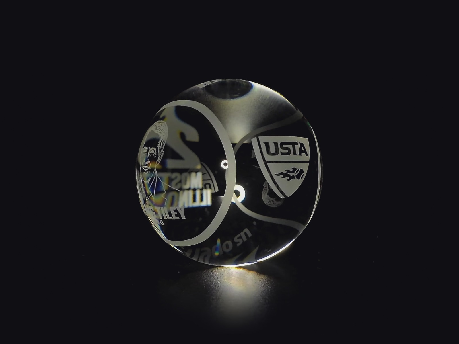 Clear crystal tennis ball with a masterfully etched USTA shield logo